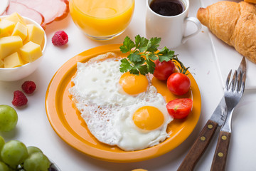 Fototapeta premium Homemade breakfast with sunny side up fried egg croissant toast coffee fruits vegetable and orange juice in top view with copy space. Delicious homemade american breakfast concept for background. Amer