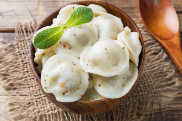 Dumplings stuffed with meat, ravioli, dumplings. Dumplings with stuffing. Russian cuisine.