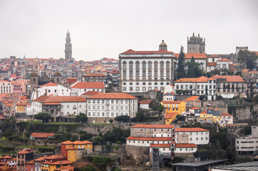 Naklejka na ściany i meble Cityscape image of Porto, Portugal, with old town Ribeira at foggy afternoon