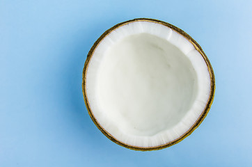 split coconut lies against a blue background