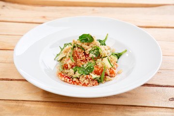 An easy, zesty summer salad with a Mediterranean flair featuring Israeli couscous and chopped summer vegetables