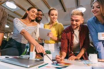 Obraz premium Young designers discussing ideas for sketches and choosing colors