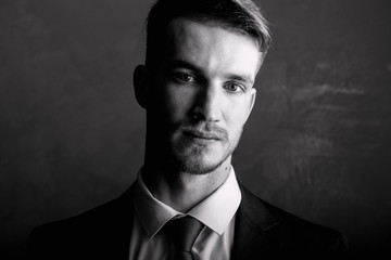 Fototapeta premium Portrait of a man black-white. Brutal man in a suit.