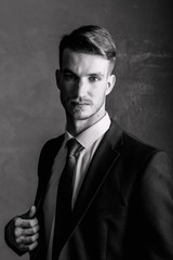 Fototapeta premium Portrait of a man black-white. Brutal man in a suit.