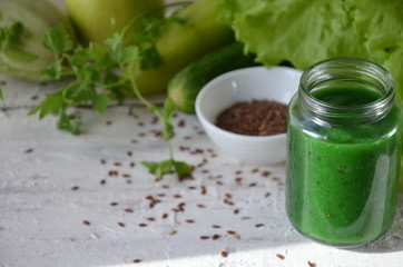 Detox diet. Green smoothie with different vegetables on white wooden background copy space. diet vegitarians healthy low calorie food. salad, greens, green apple chia or flax linen seeds