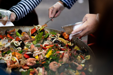 cooking vegetables. Stewing vegetables in a huge plate paella