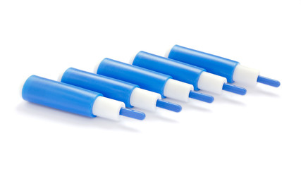 Blue lancets on a white background. Stack of blue lancets for a diabetes test on a white background. Blue blood lancets for measuring glucose in patients with diabetes isolated on a white background.