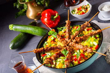 Lamb skewers with curry rice and different vegetables
