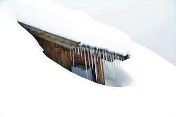 a window in the roof covered with snow