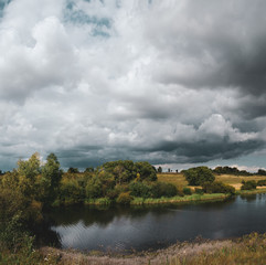 Fototapeta na wymiar Beautiful view of river and dark stormy clouds over the land