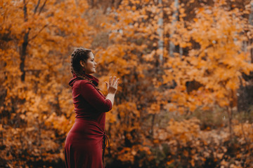 Curvy girl doing yoga in nature.