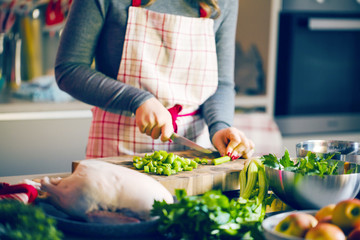 Young Woman Cooking in the kitchen. Healthy Food for Christmas (stuffed duck or Goose)
