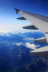 Fototapeta premium Airplane flies over the mountains