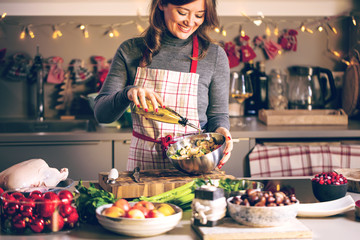 Young Woman Cooking in the kitchen. Healthy Food for Christmas (stuffed duck or Goose) - 296155543