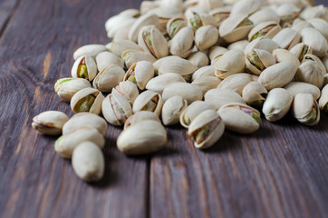 Pistachios on a dark wooden background. Selective focus