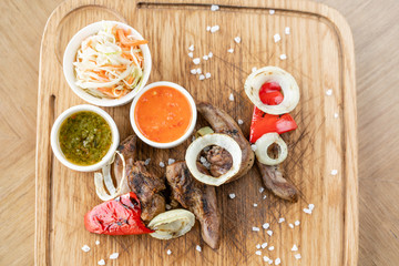 Lamb tongue kebab with Pickled cabbage and two sauces. Serving on a wooden Board. Barbecue restaurant menu, a series of photos of different meats.