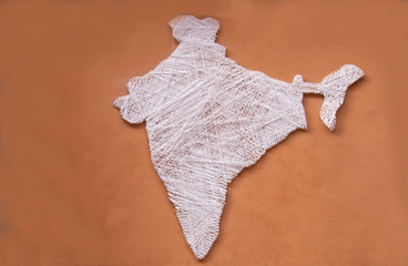 Indian map made of silk thread on plane brown wall