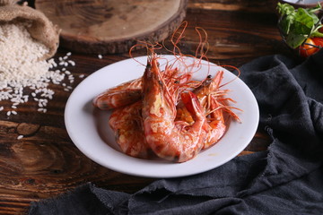 Plate of red King prawns on table in rustic kitchen