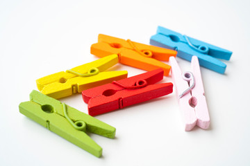 Colorful wooden clothespins on isolated white background