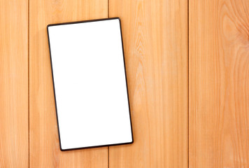 Tablet pc with empty blank white screen on wooden background. Mockup