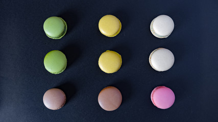 macarons seen from above on a black background