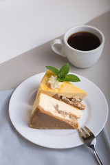 Caramel apple pecan cheesecake. Close up side view with a white wood background. Autumn dessert.