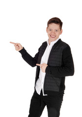 Smiling young teen boy standing, pointing with his fingers