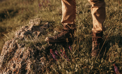 Crop hiker standing in countryside