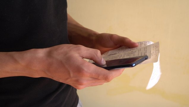 Scanning a QR code from a receipt. Smartphone app for online expense tracking