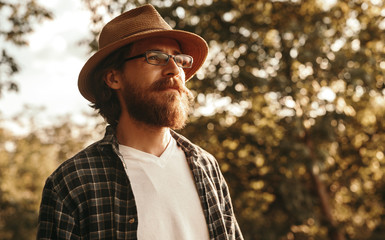 Dreamy bearded hiker in countryside
