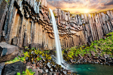 Sunset over beautiful Svartifoss waterfall. Location Skaftafell National Park, Vatnajokull glacier,...