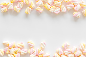 Candies. Marshmallows frame on white background top view copy space