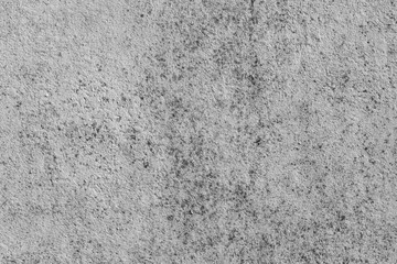 Beautiful horizontal texture of part of old concrete wall painted in white color and with holes