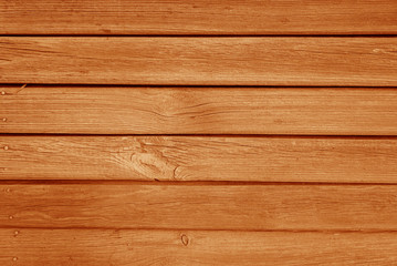 Old grungy wooden planks background in orange color.