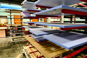 Photo workshop for painting and assembling furniture. Parts and tools for manufacturing and painting parts are depicted.