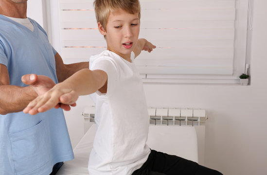 Physiotherapy for school boy , Children Poor Posture Correction, Scoliosis examination . Kinesiology treatment