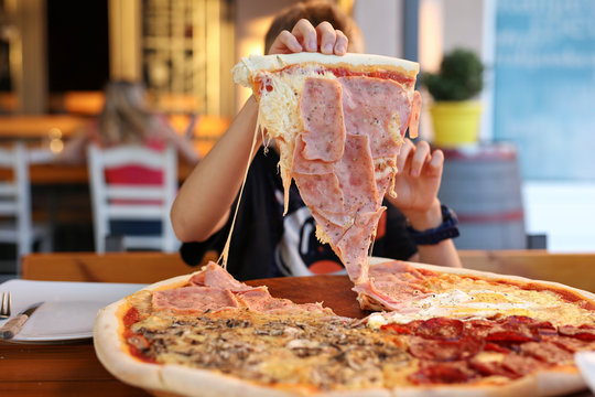 Kid Taking Big Piece Of Pizza. Enjoying Family Meal Concept