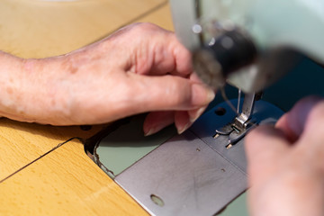 young woman working on sewing machine