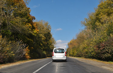 Autumn landscape with road and cars