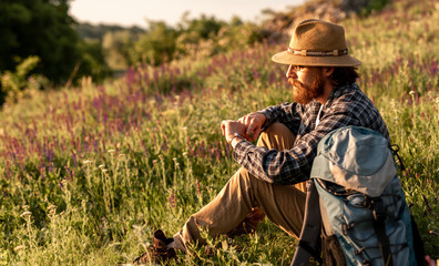Discoverer checking time in countryside