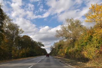 Autumn landscape with road and cars