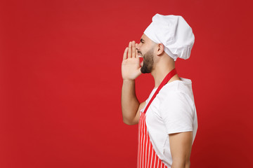 Side view of bearded male chef cook or baker man in striped apron toque chefs hat posing isolated...