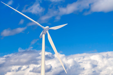 Wind power plant with copy space. Wind farm against a blue sky with white clouds.