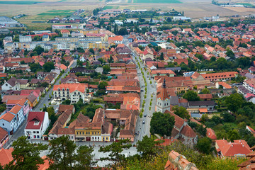 Panorama of the historic city center from the balcony of the medieval fortress Rasnov, Romania. City landscape of the ancient town.
