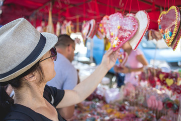 An adult woman looks at the goods at the market