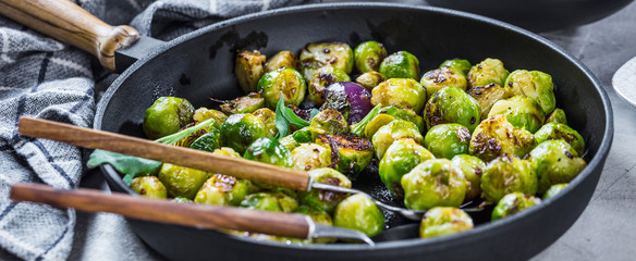 Frying pan with roasted brussel sprouts on table
