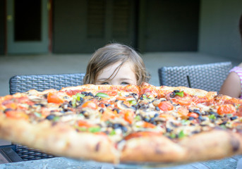 Girl with large pizza