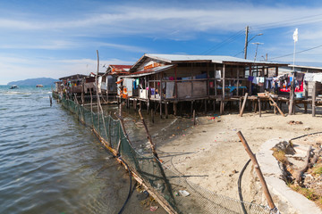 Poor wooden houses and footbridges on stilts