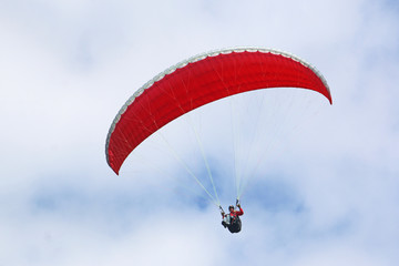 Paraglider flying wing in a blue sky