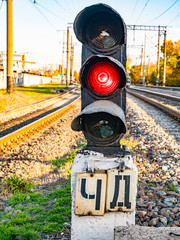 Railway traffic light of red color.